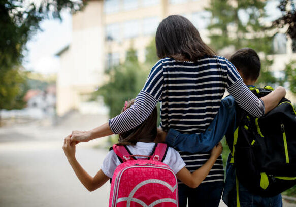 Mother taking kids to school